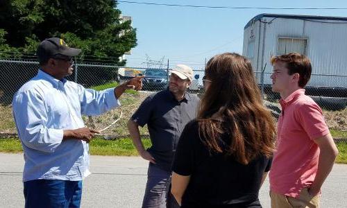 Community activist giving tour of hazardous site.