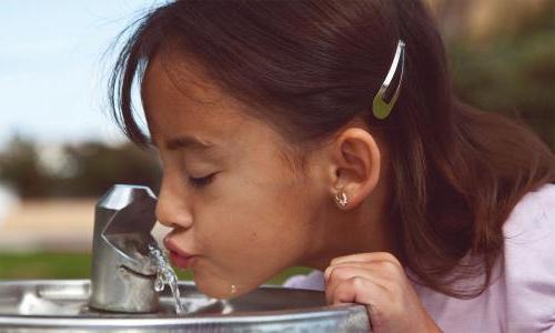 Girl drinking from water fountain
